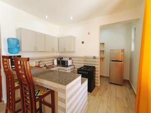 a kitchen with white cabinets and a counter top at V-Szameitat Homes, Kongo River in Diani Beach