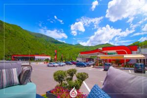 a gas station with cars parked in a parking lot at NBT Hotel Reps in Kukës