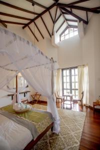 a bedroom with a large bed with a canopy at Manuel Manor in Labugolla