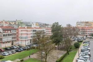 a city with cars parked in a parking lot at Cozy one bedroom apartment in Lisbon