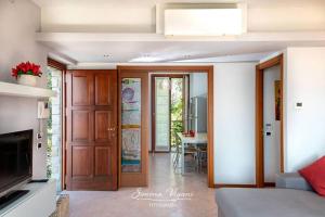 a living room with a door leading to a dining room at Casa Acqua in Riva di Solto