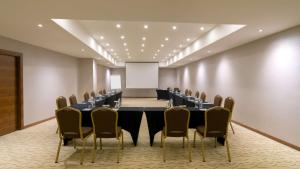 a conference room with a table and chairs and a whiteboard at Park Inn by Radisson Istanbul Asia Kavacik in Istanbul