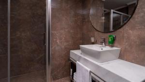 a bathroom with a sink and a shower with a mirror at Park Inn by Radisson Istanbul Asia Kavacik in Istanbul