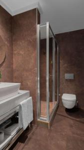 a bathroom with a shower and a toilet and a sink at Park Inn by Radisson Istanbul Asia Kavacik in Istanbul