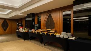 a long table with plates and drinks on it at Park Inn by Radisson Istanbul Asia Kavacik in Istanbul