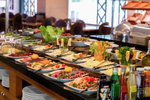 a buffet with many plates of food on a table at Park Inn by Radisson Istanbul Asia Kavacik in Istanbul