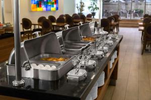 a buffet line with eggs in trays in a restaurant at Park Inn by Radisson Istanbul Asia Kavacik in Istanbul