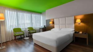 a bedroom with a white bed and a green ceiling at Park Inn by Radisson Istanbul Asia Kavacik in Istanbul