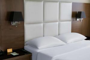 a white bed with a white headboard in a room at Park Inn by Radisson Istanbul Asia Kavacik in Istanbul