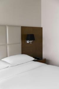 a bedroom with a white bed and a lamp at Park Inn by Radisson Istanbul Asia Kavacik in Istanbul