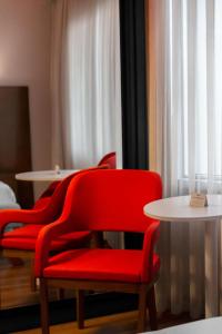 a red chair and a table in a room at Park Inn by Radisson Istanbul Asia Kavacik in Istanbul