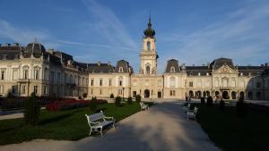 a large building with a clock tower in the distance at Szatmári Vendégház in Balatonlelle