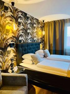 a bedroom with two beds and a couch at Palm Tree Hotel, Best Western Signature Collection in Trelleborg