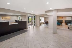 an empty lobby of a hospital with a reception desk at Clarion Pointe Indianapolis Northeast in Castleton