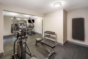 a gym with several tread machines in a room at Clarion Pointe Indianapolis Northeast in Castleton