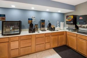 a fast food counter with a television and machines at Clarion Pointe Indianapolis Northeast in Castleton +39 photos