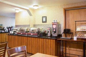 a fast food restaurant with a counter with a coffee maker at Wingate by Wyndham Anchorage Downtown - Ship Creek in Anchorage