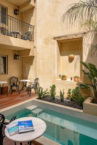 a patio with a pool and a table and chairs at Casa di Gaga in Rethymno