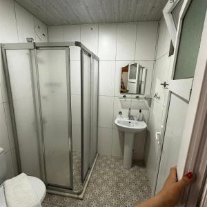 a bathroom with a shower and a sink at Adrasan Akasya Pansiyon in Kumluca