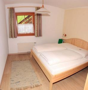 a bedroom with a large bed in a room at Schuistlhof in Sillian