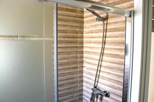 a shower in a bathroom with a glass door at Mi UNIVERSO in San Fernando +12 photos