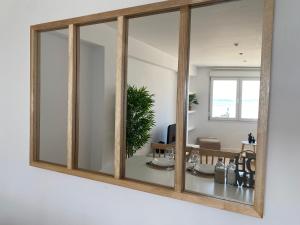 a mirror on a wall in a living room at Arenaysal Home in Sanxenxo +18 photos