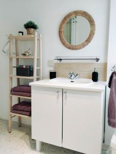 a bathroom with a white sink and a mirror at Gistiheimilið Bergistangi 1 in Norðurfjörður