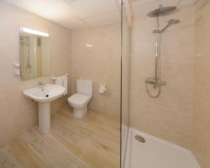 a bathroom with a toilet and a sink and a shower at Sunside Ibiza Studios - Only Adults- Formerly known as Central Park in San Antonio