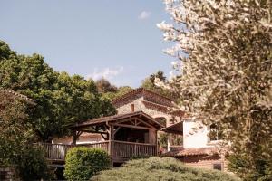 a house with a gazebo in the middle of trees at INSPIRE Villages - Anduze in Corbés