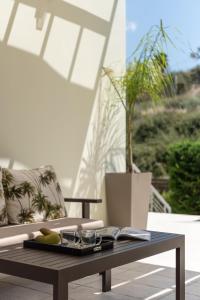a coffee table with a tray of food on a patio at Mela Villas in Maroulás