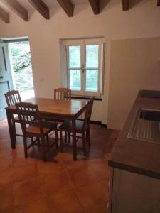 a dining room with a wooden table and chairs at Casa dell'Arco 31 in Camogli