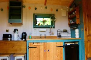 a kitchen with a counter with a sink and a mirror at Bexhill Old Town Retreat in Bexhill