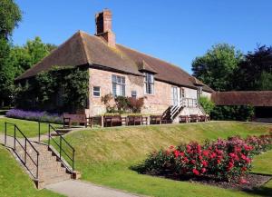 a large brick house with a porch and flowers at Bexhill Old Town Retreat in Bexhill