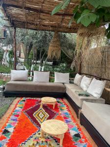 a living room with a couch and a rug at Dar Tadout in Aït Ourir