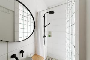 a bathroom with a sink and a mirror at Loft Apartment in Ivano-Frankivsʼk