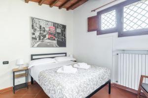 a bedroom with a bed with two towels on it at Settignano Quiet Apartment with Private Parking in Settignano