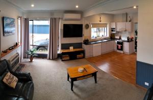 a living room with a couch and a table at Ocean views in Portland