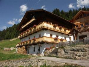 a building with flowers on the balconies of it at Schuistlhof in Sillian