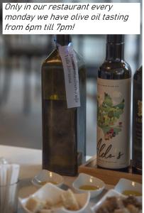 a bottle of wine sitting next to a bottle of food at Wellness Villa Istriana in Umag