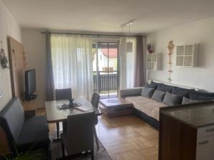 a living room with a couch and a table at Wohnhaus City Süd in Herzogsdorf