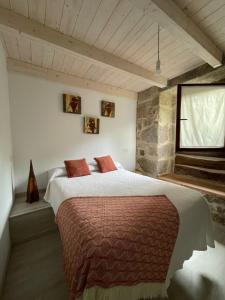 a bedroom with a large bed and a window at As Fontaiñas in Beiro +42 photos