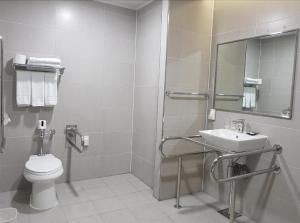 a bathroom with a toilet and a sink at Hotel Ciel Dongtan in Hwaseong