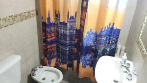 a bathroom with a toilet and a shower curtain at Nice Full Apartment Downtown Salta in Salta