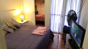 a bedroom with a bed and a flat screen tv at Nice Full Apartment Downtown Salta in Salta