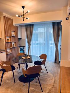 a dining room with a table and chairs at DAMAR Infinity Beach and Pool Mamaia- private parking in Mamaia Sat/Năvodari