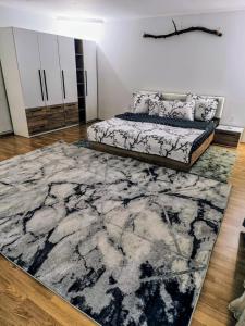 a bedroom with a bed and a rug at Casa Teresa in Cluj-Napoca