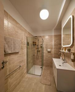 a bathroom with a shower and a sink at City Apartman Székesfehérvár in Székesfehérvár