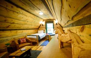a log cabin room with a bed and a bedroom at Vikings Villages Resort in Guilford