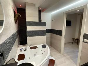 a bathroom with a bath tub and a sink at Alloggio in Via del Pescino in Bracciano +22 photos