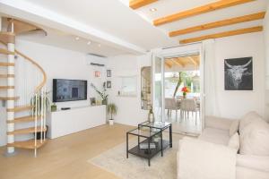 a living room with a couch and a table at Holiday home Country retreat in Višnjan